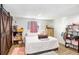 Bedroom with barn door, wood floors, a window with blinds, and playful decor at 9040 Lunar Ln, Port Richey, FL 34668