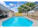 Gorgeous screened-in pool showcasing a private backyard oasis, perfect for relaxation and fun at 9040 Lunar Ln, Port Richey, FL 34668