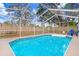 Inviting screened-in pool provides ample space for swimming, recreation, and leisure at 9040 Lunar Ln, Port Richey, FL 34668