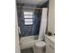 Updated bathroom features a blue-tile shower with modern fixtures and a clean, bright design at 1003 Engman St, Clearwater, FL 33755