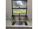 Stylish kitchen sink with brass faucet, quartz counters, and a view of the landscaped backyard at 1003 Engman St, Clearwater, FL 33755