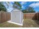 Fenced backyard showcasing a storage shed and grassy area, providing ample space at 1053 56Th N Ave, St Petersburg, FL 33703