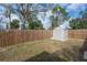 Fenced backyard with a shed, offering additional outdoor storage and a secure space at 1053 56Th N Ave, St Petersburg, FL 33703