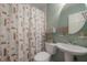 Bathroom with a pedestal sink, sea-themed shower curtain and tiled floor at 1053 56Th N Ave, St Petersburg, FL 33703