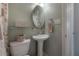 Cozy bathroom features a pedestal sink, decorative accents, and a neutral color scheme at 1053 56Th N Ave, St Petersburg, FL 33703