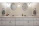 Bright bathroom vanity featuring dual sinks, mirrors, updated fixtures, and plenty of storage at 1053 56Th N Ave, St Petersburg, FL 33703