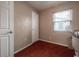 Bedroom with a window and door, partially filled with moving boxes at 1053 56Th N Ave, St Petersburg, FL 33703