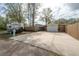 Wide concrete driveway leads to a detached garage and covered carport at 1053 56Th N Ave, St Petersburg, FL 33703