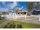 Charming home with a white picket fence and a well-manicured front yard at 1053 56Th N Ave, St Petersburg, FL 33703