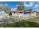 Charming home with a white picket fence and a well-manicured front yard at 1053 56Th N Ave, St Petersburg, FL 33703