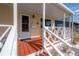 Attractive front porch, painted railings, and colorful orange seating at 1053 56Th N Ave, St Petersburg, FL 33703