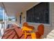 Inviting front porch featuring a unique orange table and chair set at 1053 56Th N Ave, St Petersburg, FL 33703