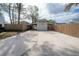 Spacious concrete driveway leads to a detached garage and a gated entrance at 1053 56Th N Ave, St Petersburg, FL 33703