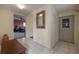 Hallway featuring neutral walls, closet and decorative mirror leading to other rooms at 1053 56Th N Ave, St Petersburg, FL 33703