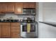 Kitchen boasts stainless steel appliances, wood cabinets, and a breakfast bar at 1053 56Th N Ave, St Petersburg, FL 33703