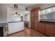 Kitchen with dark countertops, wood cabinetry, and a view into the dining area at 1053 56Th N Ave, St Petersburg, FL 33703