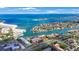 Gorgeous aerial view of waterfront property, showcasing the turquoise ocean, community, and nearby beaches at 1060 Pinellas Bayway S # 103, St Petersburg, FL 33715