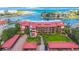 Aerial view of complex, including covered parking, lush grounds and ocean access at 1060 Pinellas Bayway S # 103, St Petersburg, FL 33715