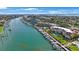 Beautiful aerial shot of waterfront property, featuring boat docks, turquoise water, and lush landscaping at 1060 Pinellas Bayway S # 103, St Petersburg, FL 33715