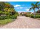 Long brick driveway leads to this building with well-maintained landscaping and a porte cochere at 1060 Pinellas Bayway S # 103, St Petersburg, FL 33715