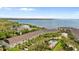 Aerial view of a community overlooking the bay, featuring a community pool and manicured landscaping at 112 Brent Cir, Oldsmar, FL 34677