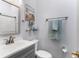 Well-lit bathroom featuring a vanity with a gray cabinet and a framed mirror and soft blue accents at 112 Brent Cir, Oldsmar, FL 34677