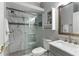 Modern bathroom featuring a glass-enclosed shower with white and grey marble at 112 Brent Cir, Oldsmar, FL 34677