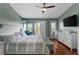 Large bedroom with balcony access, hardwood floors, ceiling fan at 112 Brent Cir, Oldsmar, FL 34677