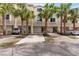 Condo exterior showcasing a two-car garage, brick driveway, and a well-manicured landscape at 112 Brent Cir, Oldsmar, FL 34677