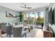 Bright living room with comfortable seating, a ceiling fan, and a sliding glass door to the patio at 112 Brent Cir, Oldsmar, FL 34677