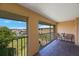 Balcony view with seating overlooking lush landscaping and waterfront homes at 1125 Pinellas Bayway S # 305, St Petersburg, FL 33715