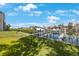 View of a private boat dock on a sunny day with tropical landscaping and clear blue skies at 1125 Pinellas Bayway S # 305, St Petersburg, FL 33715