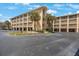 Exterior view of a multi-story condominium building with covered parking at 1125 Pinellas Bayway S # 305, St Petersburg, FL 33715