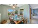 Dining room with wood table and chairs, light green walls, and water views from the windows at 1125 Pinellas Bayway S # 305, St Petersburg, FL 33715