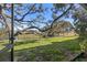 Backyard with a view of an open grass yard and a pond in the distance, great for relaxing outdoors at 11410 Carriage Hill Dr # 3, Port Richey, FL 34668