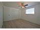 Neutral bedroom with wood-look floors, a ceiling fan, and a spacious closet for storage at 1152 Viking Dr, Holiday, FL 34691