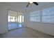 Bright bedroom featuring a sliding glass door to a screened lanai and neutral flooring at 1152 Viking Dr, Holiday, FL 34691