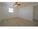 Serene bedroom featuring wood-look floors, ceiling fan, and a window for natural light at 1152 Viking Dr, Holiday, FL 34691