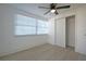 Bedroom featuring a large window for natural light and a closet with sliding doors at 1152 Viking Dr, Holiday, FL 34691