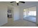 Bedroom featuring a glimpse into the kitchen and sliding doors to the screened patio at 1152 Viking Dr, Holiday, FL 34691