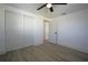 Spacious bedroom featuring wood-look floors, closet, and an open door at 1152 Viking Dr, Holiday, FL 34691