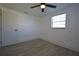 Bedroom with neutral paint, a large window for natural light, and wood-look flooring at 1152 Viking Dr, Holiday, FL 34691