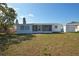 Exterior view of a single-story home with a screened lanai and shed in the backyard at 1152 Viking Dr, Holiday, FL 34691