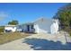 Exterior view of home with a neatly paved driveway and manicured lawn at 1152 Viking Dr, Holiday, FL 34691