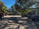 Parking lot view surrounded by trees with plenty of parking spaces available at 11723 Raintree Village Blvd # B, Temple Terrace, FL 33617