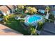 Community pool surrounded by lush landscaping, picnic area, and buildings at 11901 4Th N St # 10102, St Petersburg, FL 33716