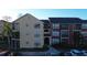 Exterior angle showing a condo building with tan and red accents; includes parking and surrounding palm trees at 11901 4Th N St # 10102, St Petersburg, FL 33716