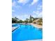 Beautiful community pool, surrounded by lounge chairs and vibrant tropical landscaping at 11901 4Th N St # 10102, St Petersburg, FL 33716