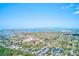 Stunning aerial view of waterfront community with city skyline in the distance at 12607 San Blas Loop, Largo, FL 33774