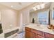 Well-lit bathroom featuring a shower/tub and a wood vanity at 12607 San Blas Loop, Largo, FL 33774